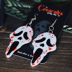 These unique Bloody Ghost Killer horror earrings are lightweight and perfect if you love to stand out from the crowd! They add a dark and spooky look to any outfit! They're the perfect little gift for your spooky friend or yourself😉!Approximately 1" x 3" in length (including hook)All Jewelry is made with skin-friendly metal alloy hooks (nickel-free & lead-free!) Halloween Novelty Jewelry For Cosplay, Halloween Cosplay Novelty Jewelry, Spooky Red Halloween Jewelry, Black Earrings For Halloween Cosplay, Black Halloween Cosplay Earrings, Spooky Handmade Earrings For Halloween, Punk Halloween Drop Earrings, Spooky Handmade Halloween Earrings, Handmade Spooky Halloween Earrings