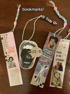 three bookmarks are hanging on a table with beads and other items around them,