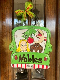 a green sign that says mobles mean on the front door