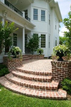 brick steps lead up to a large white house