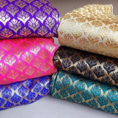 several different colored fabrics stacked on top of each other