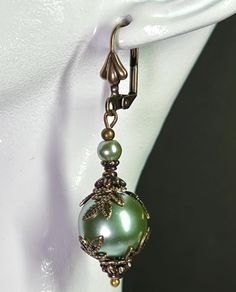 Sage Green Pearl Earrings adorned with Vintage looking Antiqued brass bead caps. These Victorian Style Earrings are just under 2 inches long and come in a gift box or a gift bag. Green Pearl Earrings, Wedding Earrings Pearl, Victorian Style Earrings, Pearl Earrings Wedding, Vintage Style Earrings, Green Pearls, Earrings Pearl, Earrings Green, Wedding Jewelry Earrings