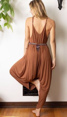 Easy-to-wear jumpsuit is one-size-fits-all with straps that can be adjusted for length. Beautiful earth tone color to complement your closet! Soft material is perfect for rolling up and stowing in your suitcase. Flowing fabric makes inversions fun! Another fun way to wear this style is adjust the steps to the biggest & criss cross at the neck. Great styled solo, layered over leggings or under a cropped jacket paired with chunky heeled mules. One size fits most fits 0-14. Jersey Knit blend to giv Brown Summer Jumpsuits And Rompers For Loungewear, Summer Brown Jumpsuits And Rompers For Loungewear, Sleeveless Brown Jumpsuits And Rompers For Beach, Sleeveless Brown Jumpsuit For Beach, Sleeveless Brown Jumpsuit For The Beach, Brown Sleeveless Jumpsuits And Rompers For Vacation, Brown Sleeveless Jumpsuit For Vacation, Sleeveless Brown Jumpsuit For Vacation, Jumpsuit With Pockets