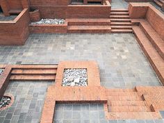 an aerial view of a courtyard with steps and benches