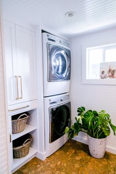 a washer and dryer sitting next to each other in a room with white walls