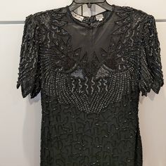 Black, Elegant Beaded Dress For A Formal Wedding Event Or Roaring Twenties Ball. Has Cap Sleeve Bodice And Intricate Embellishment Throughout. The Full-Length Skirt Has A Unique, Zig Zag Seam. Never Worn After Purchasing (Vintage) As It Was A Little Too Slim For My Bust. Please Reach Out With Questions Or Reasonable Offer. Thank You. Roaring 20s, Black Tie, Petite Elegant Formal Floor-length Flapper Dress, Elegant Sequined Flapper Dress For Formal Occasions, Embellished Gatsby Style Formal Dress, Gatsby Style Embellished Formal Dress, Elegant Formal Sequined Flapper Dress, Elegant Formal Flapper Dress With Sequins, Formal Gatsby Embellished Dress, Elegant Fitted Floor-length Flapper Dress, Fitted Black Gatsby Evening Dress