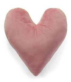 a pink heart shaped pillow on a white background