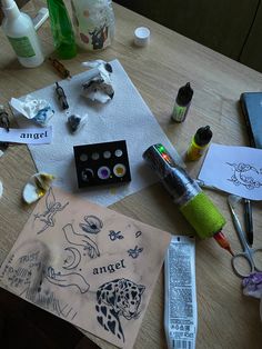 the table is cluttered with art supplies such as pens, markers, and paper