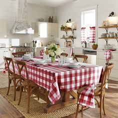 a dining room table with red and white checkered cloths on the tablecloth