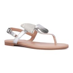 From the beach to the boardwalk, the Abril sandal is a quintessential summer essential. Its minimalistic design, adorned with a charming bow detail, adds a touch of femininity to any outfit. Perfect for warm weather, this versatile sandal effortlessly enhances your summer style, making it a must-have for your seasonal wardrobe. Spring Flat T-strap Sandals With Buckle Closure, Spring Flat T-strap Synthetic Sandals, Spring T-strap Sandals With Adjustable Buckle Closure, Beach T-strap Sandals With Buckle Closure, Effortless Chic Style, White T-strap Sandals With Buckle Closure For Beach, T Strap Flats, Seasonal Wardrobe, Rhinestone Flats