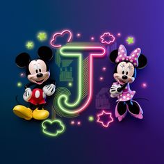 mickey and minnie mouse standing next to each other in front of a neon letter j