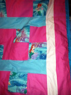 the little mermaid quilt is made with pink and blue fabric