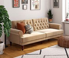 a living room filled with lots of furniture and decor on top of a hard wood floor