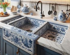 a kitchen with blue and white tiles on the sink