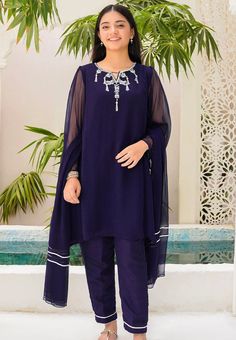 3- Piece Embroidered Suit for Girls Description : Top: Navy Blue Chiffon Kurta with Hand Adda Work and Malai Crepe Lining Bottom: Navy Blue Raw Silk Trouser Dupatta: Navy Blue Chiffon Dupatta with Laces Country of Origin : Pakistan General Care Instruction : Should be washed in gentle cycle and hung to dry. Color may bleed so please be mindful of other items with it. General Disclaimer: Size chart provides reference sizes and actual sizes might be slightly different from the size chart. Actual c Blue Georgette Kurta For Summer, Summer Blue Georgette Kurta, Blue Organza Kurta With Dabka Details, Blue Organza Kurta With Dabka Embroidery, Blue Organza Sets With Dabka Detailing, Blue Georgette Dress With Sheer Dupatta, Blue Organza Sets With Dabka Embroidery, Purple Long Sleeve Dress With Sheer Dupatta, Unstitched Chiffon Sets For Summer