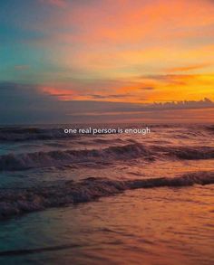 an ocean with waves and the words one real person is enough on it at sunset