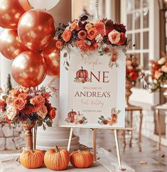 there is a sign that says one andreas next to some pumpkins on the table