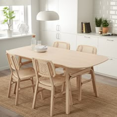 a dining room table with four chairs around it