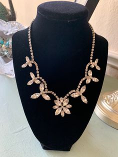 "Absolutely magnificent  sparkling white rhinestone necklace   Measuring approximately 15\".  Look carefully at the last picture. This is not a \"flat\" piece. Instead each of the accents sits upright on the neck. Beautiful bridal gift.  Red carpet item. So many options.  There are a few darker rhinestones on the chain, they are impossible to show in a picture. But they not detract to the overall brilliance of this necklace." White Crystal Rhinestone Necklace In Costume Jewelry Style, White Crystal Rhinestone Costume Jewelry Necklace, White Crystal Rhinestone Costume Necklace, Anniversary Crystal Rhinestone Costume Necklace, Anniversary Costume Jewelry Rhinestone Necklace, Anniversary Costume Rhinestone Crystal Necklace, Vintage Rhinestone Necklace, Bridal Gift, White Rhinestone