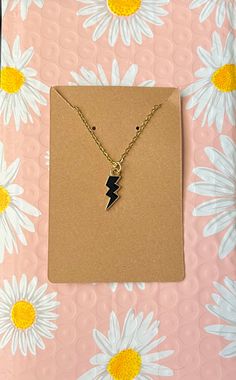 This is a lightning bolt chained necklace worn around the neck. Edgy Adjustable Chain Necklace For Gifts, Edgy Gold Necklace For Gifts, Edgy Gold Necklace For Gift, Gold Lightning Bolt Jewelry Gift, Gold Lightning Bolt Jewelry For Gift, Lightning Bolt Jewelry, Chained Necklace, Necklaces Gold, Spring Set