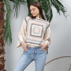 This cozy and unique sweater is a bohemian-inspired masterpiece, perfect for anyone who loves a vintage and handmade touch. The sweater is crafted using the traditional crochet technique of making granny squares, which are then pieced together to create a gorgeous and colorful pattern. The soft and warm yarn used for this sweater is carefully selected for its quality and texture, ensuring that the finished garment will feel comfortable and last for years to come. The colors used in the granny sq Cream Long Sleeve Crochet Top, Bohemian Style, Bohemian Yarn Crochet Top, Handmade Bohemian Crochet Long Sleeve Top, Handmade Bohemian Long Sleeve Crochet Top, Beige Long Sleeve Bohemian Sweater, Bohemian Knitted Poncho For Spring, One Size Bohemian Crochet Knit Top, Cozy Cream Crochet Sweater, Bohemian Knitted Crochet Top For Winter