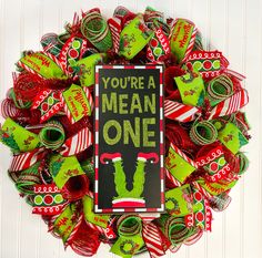 a christmas wreath that says you're a mean one with candy in the middle