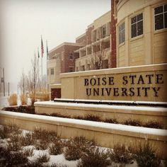 the sign for boise state university is covered in snow and grass on a snowy day