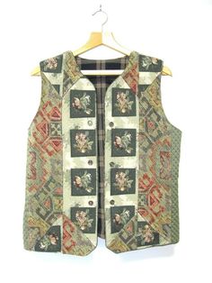 A unique vintage patchwork tapestry vest with geometric and floral patterns, Women's M  Very well made and looks to be handmade. The back is brocade "carpet". The inside of the vest is also lovely! The buttons are clear iridescent (really nice) and are for show only. This beauty is to be worn open. The rustic colors are great for any season. Please use measurements as your guide and feel free to ask any questions! Measurements: Bust: 20" from armpit to armpit while lying flat with fron Vest Patchwork Vintage, Retro Patchwork Vest For Fall, Vintage Green Vest For Fall, Green Vintage Vest For Fall, Unique Vest, Patchwork Tapestry, Tapestry Vest, Clothing Pieces, Rustic Colors