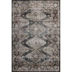 an area rug with various colors and patterns on the floor, including black, grey, beige