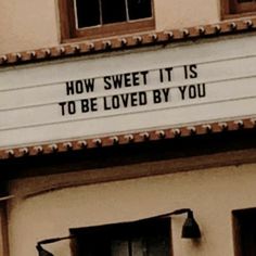 a sign on the side of a building that says how sweet it is to be loved by you