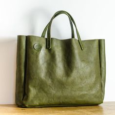 Olive Green Italian Leather Box Bag  Each bag is made from Full Grain, World Famous Badalassi Carlo Leather and is finished with hand stitched  handles in the same leather. This leather bag is the perfect size for use as an everyday carryall, as a stylish work bag or a weekend bag. Item Details: * Handmade in Manchester, England * Premium Quality Full Grain Badalassi Carlo Italian Leather  * Hand-stitched  Approx. external dimensions: Width: 40cm (15.75") Height: 33cm (13") Depth: 10cm (4") Bada Green Rectangular Leather Bag, Leather Square Box Bag For Errands, Green Rectangular Briefcase, Green Rectangular Leather-lined Bag, Green Leather Box Bag With Large Capacity, Rectangular Leather Box Bag For Errands, Rectangular Recycled Leather Bag, Green Square Leather Box Bag, Green Leather Shoulder Bag Briefcase