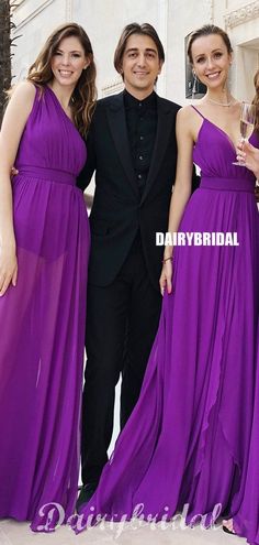 three women in purple dresses standing next to each other and one man wearing a tuxedo