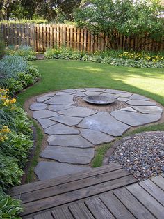 a small garden with a fire pit in the middle