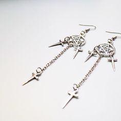 These dark and alluring Dagger Earrings. Measuring 3.5 inches in length, these alloyed earrings are perfect for adding a touch of edgy style to any outfit. Make a statement and stand out from the crowd with this must-have accessory. Gothic Metal Plug Earrings With Ear Wire, Punk Style Metal Jewelry With Ear Wire, Edgy Nickel-free Dangle Plug Earrings, Edgy Pierced Metal Earrings, Gothic Dangle Metal Plug Earrings, Gothic Metal Dangle Plug Earrings, Punk Style Metal Dangle Hoop Earrings, Edgy Metal Drop Plug Earrings, Edgy Metal Dangle Hoop Earrings