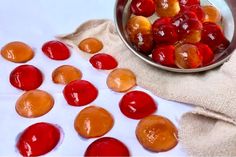 a bowl filled with jelly beans next to a cloth