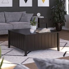 a living room scene with focus on the coffee table and grey sofas in the background