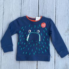 Brand New With Tags Blue Crew Neck Sweatshirt For Playwear, Blue Crew Neck Sweatshirt For Playtime, Fun Blue Long Sleeve T-shirt, Fun Blue Cotton Sweatshirt, Blue Cotton Fun Style Sweatshirt, Blue Cartoon Print Tops For Playtime, Blue Long Sleeve Playful Top, Playful Blue Long Sleeve Top, Fun Blue Tops For Playtime