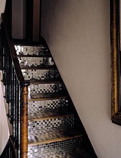 a set of stairs leading up to a tiled wall