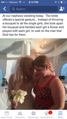 two women are hugging each other in front of a white tent with flowers on it