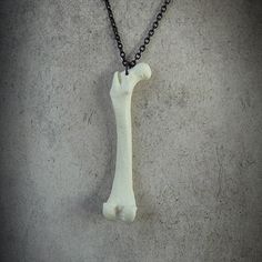 This spooky femur bone necklace is cast in durable urethane resin from a real mink femur. A creepy skeleton bone accessory that can also be worn every day for any occasion. This very popular statement piece looks stunningly creepy and eerily beautiful adorning any goth fashion style or alternative look. A very unusual gift idea for the most unique person in your life! All Raven Ranch Studio pieces are single artist created handmade resin casts (not 3D printed or mass produced). Each bone pendant Creepy Skeleton, Femur Bone, Skeleton Necklace, Unique Person, Jewelry Design Studio, Real Bones, Skeleton Bones, Bone Necklace, Bone Jewelry