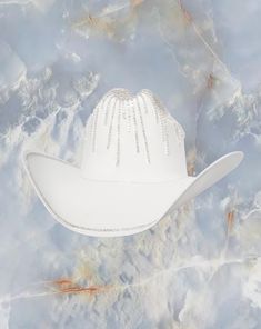 Sell your soul to the Solar Eclipse hat. The Solar Eclipse white cowboy hat is detailed with crystal around the crown and brim. Proudly American Made. Our hats are manufactured in Mexico and details added by hand in Los Angeles, CA using the highest quality materials. SIZING S/M 19in-22.75in | 48cm-57.5cm L/XL 19.5in-23.25in | 49.5cm-59cm **Please allow up to 2 weeks for production and shipping.* If you need your order rushed, please send us an email. We can almost always accommodate rushed orders at no additional cost.* CUSTOM OPTIONS AVAILABLE! White Adjustable Hat With Tall Crown, White Tall Crown Hat With Adjustable Fit, White Adjustable Tall Crown Hat, White Rhinestone Hat With Curved Brim, White Hats With Rhinestones And Curved Brim, Luxury Wide Brim White Hat, White High Crown Hat Bands For Rodeo, Elegant White Hat Band For Western-themed Events, White Western Hat With Rhinestones