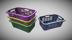 three plastic baskets sitting next to each other on a gray surface, one is purple and the other is green