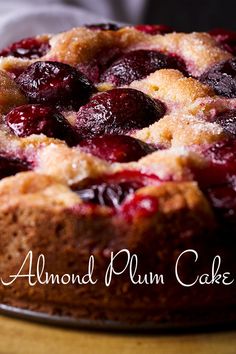 a close up of a cake on a table with the words almond plum cake above it