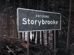 a sign that says story brooke in front of some trees and tracks on the ground