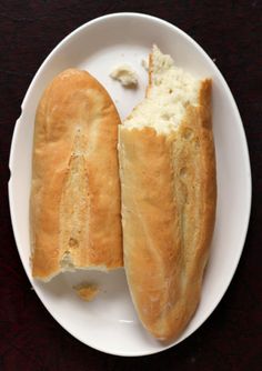 two loaves of bread on a white plate