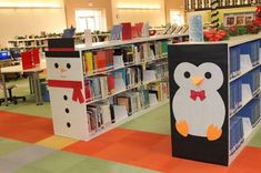 the penguin and snowman are on display in the children's bookcases