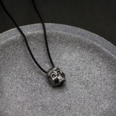 "A sterling silver necklace with a skull for men in black oxidized silver. The best Fathers Day Gift for him. DETAILS * Metal: High Quality Sterling Silver 925 * Finish: Black Oxidized * Dimensions: 20mm x 15mm * Length: 76 cm, but it can be adjustable to the preferred length. Just make a knot at the length you want and cut the rest of the cord. 100% nickel free. Delivered in an elegant gift package. S H I P P I N G All orders are now shipped via FedEx Express or DHL for speed and security (deli Black Skull Necklace With Oxidized Finish, Black Oxidized Skull Necklace, February Birthday Gifts, Viking Pendant, Cool Fathers Day Gifts, Gothic Necklace, Skull Jewelry, Skull Necklace, Gift Package