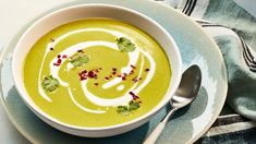 a white bowl filled with soup on top of a blue plate