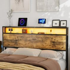 there is a bed that has been made with lights on the headboard and foot board