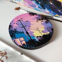 a painting on a table with paintbrushes next to it